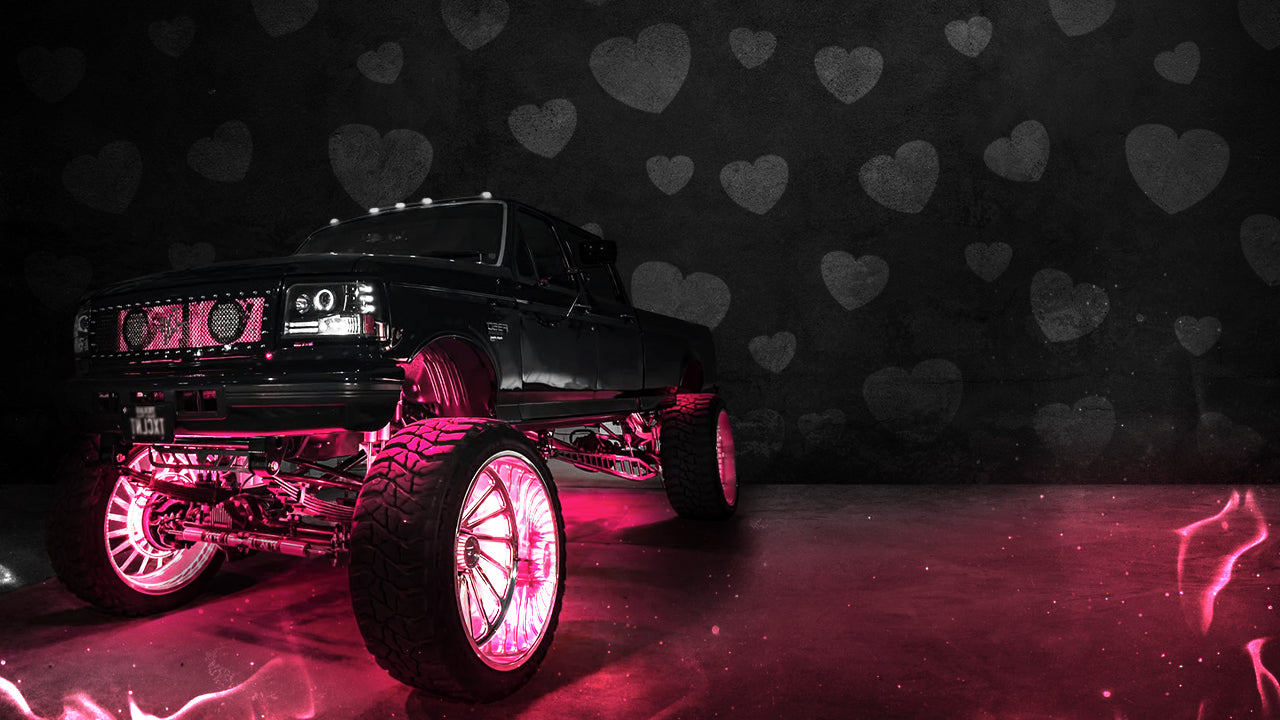 Black truck with pink accents on a dark background with heart shapes